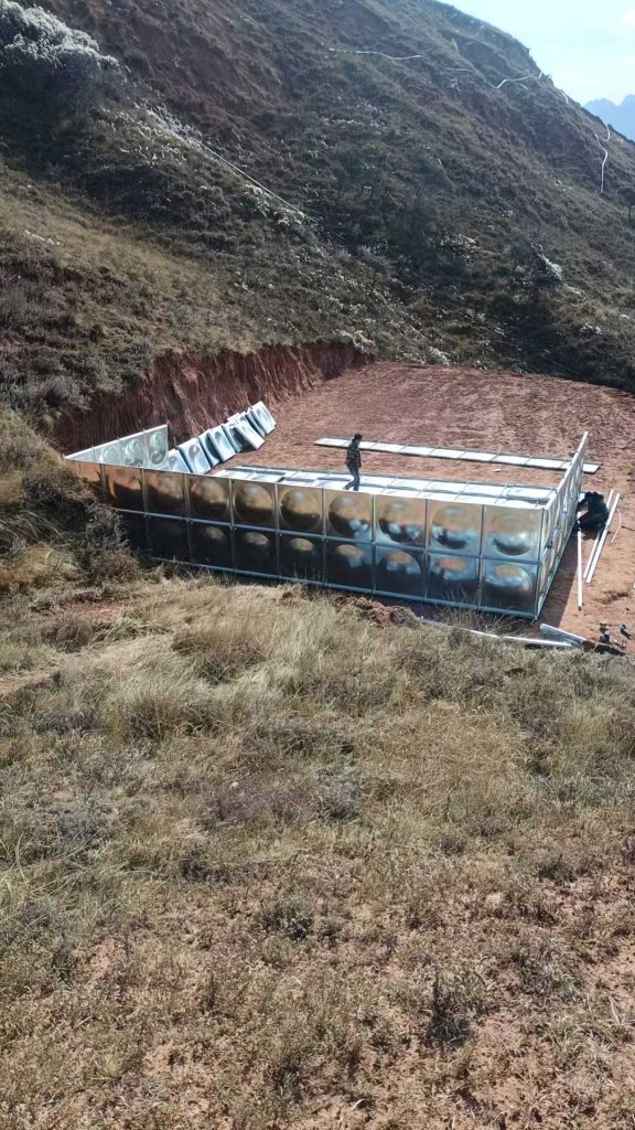 Hot-dip galvanized sectional water tank system used in highland agriculture irrigation with corrosion-resistant steel structure.
