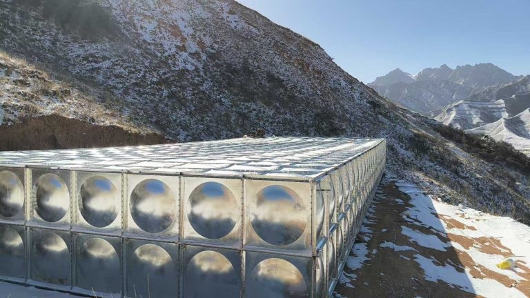 High-altitude galvanized modular water tank for agricultural irrigation and livestock water supply in remote mountainous regions.